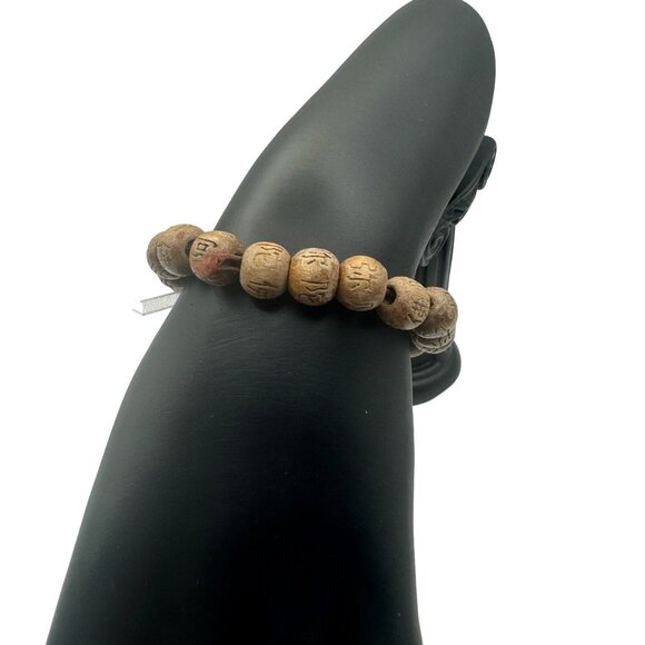 Hand-Carved Wooden Look Bead Bracelet With Intricate Symbols - Picture 3 of 5